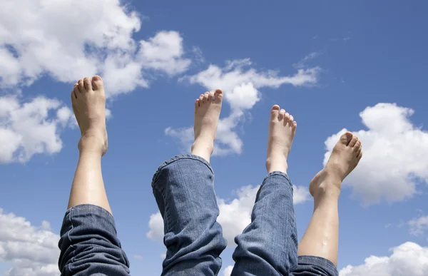 Two sets of feet in the air. — Stock Photo, Image
