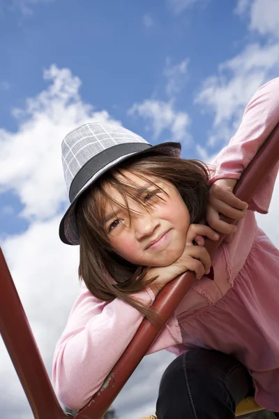 Brightly lit girl wearing hat. — Stock Photo, Image