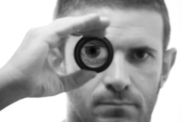 Black and white male face with magnifying lens — Stock Photo, Image