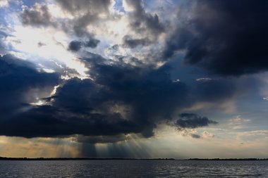 Crepuscular rays over the Tisza lake clipart