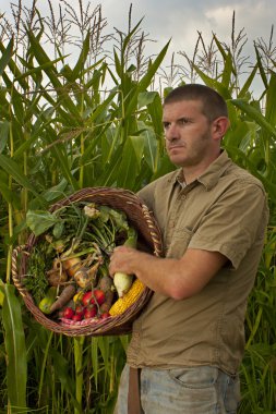 Male farmer with a mixed harvest