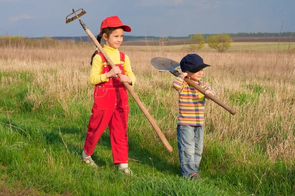 Two little children walking with tools — Stock Photo, Image