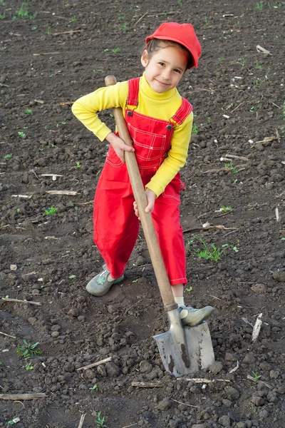 Little girl with big shovel — Stock Photo, Image