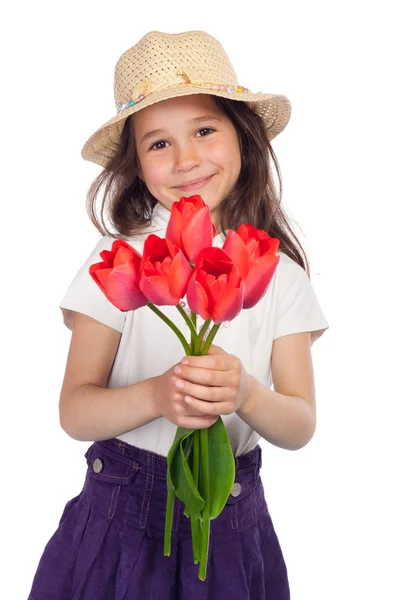 Kleines Mädchen mit roten Tulpen — Stockfoto