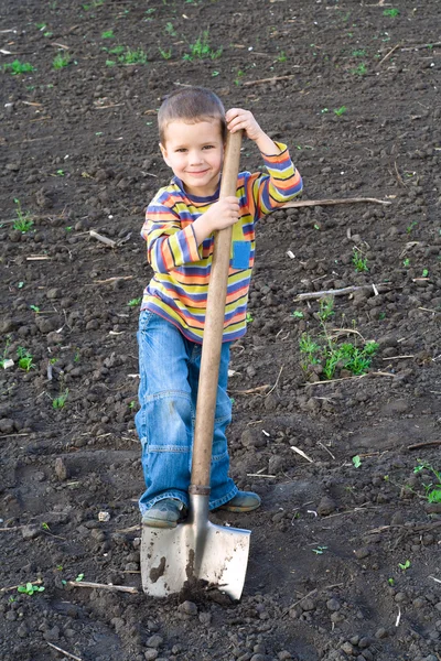 Little children with big shovel — Stock Photo, Image