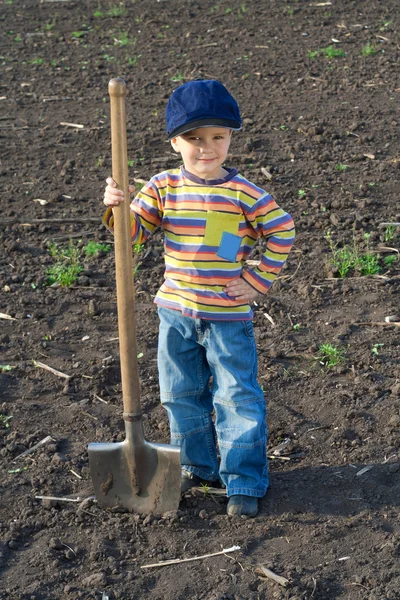 Little children with big shovel — Stock Photo, Image