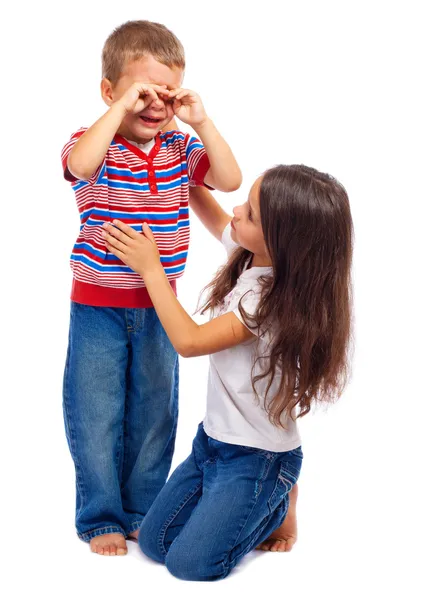 Girl calming down her little crying brother — Stock Photo, Image