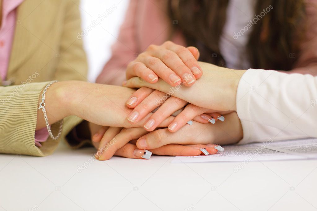 Image of business hands on top of each other