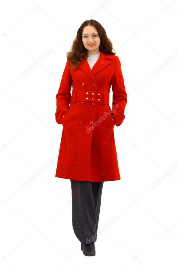 Beautiful young woman in red coat posing on white background