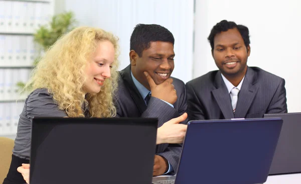 Interracial business team working at laptop in a modern office — Stock Photo, Image