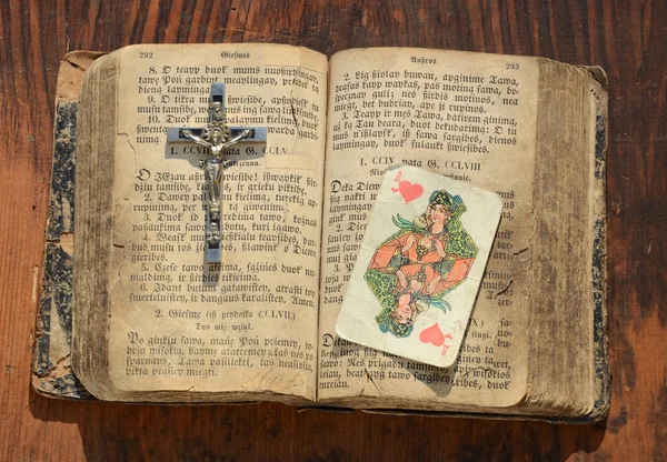 Old book with crucifixion and queen of hearts — Stock Photo, Image
