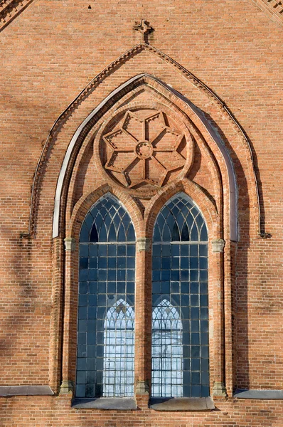 Kostelní okno a červených cihel pozadí — Stock fotografie