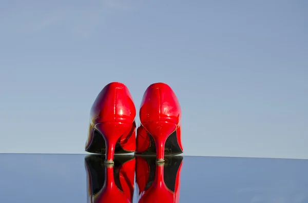 A pair of red stiletto on mirror
