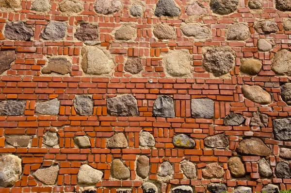 Ladrillos rojos y piedras fondo de pared — Foto de Stock