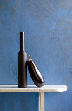 Still-life with black bottle and aubergine clipart