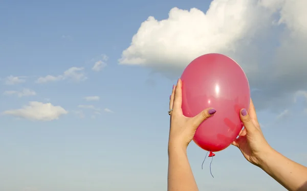 Kadının elini tutarak kırmızı balon — Stok fotoğraf