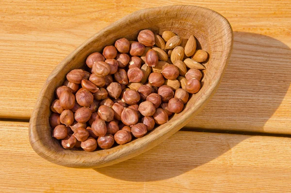 Nuts in the wooden plate — Stock Photo, Image