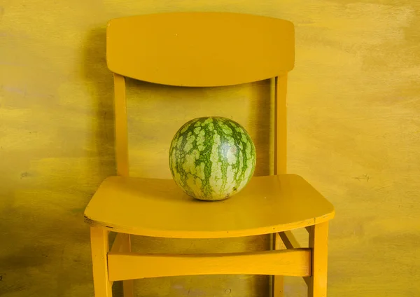 Watermeloen op de gele stoel — Stockfoto