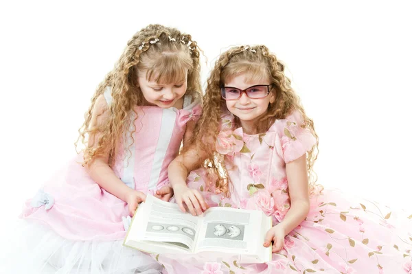 Twin princesses reading a book — Stock Photo, Image