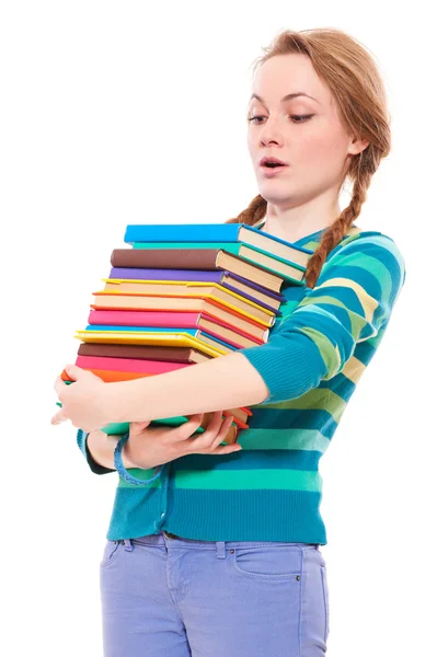 Studentin blickt auf Bücherstapel — Stockfoto