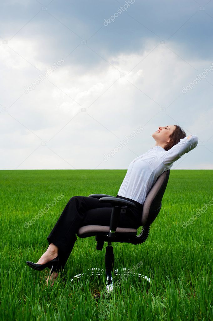 Businesswoman resting on chair