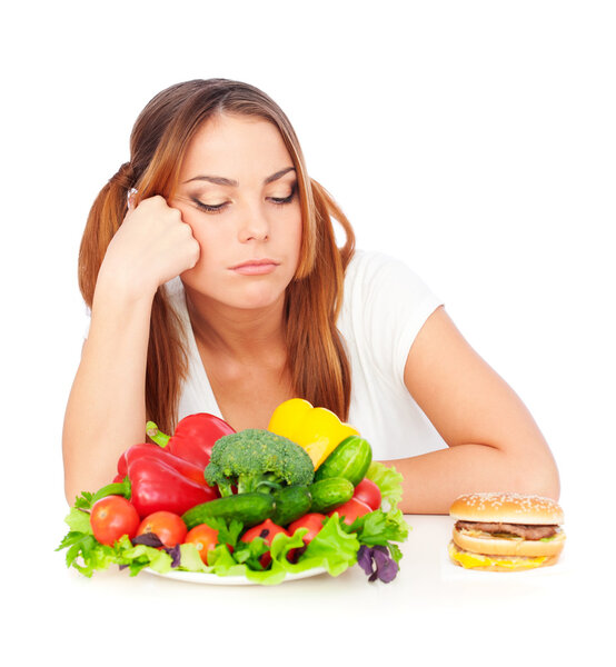 Sad woman choosing burger or vegetables