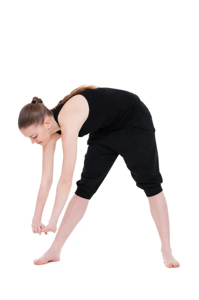 Woman in black sportswear doing stretch exercise — Zdjęcie stockowe