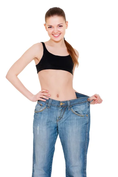 Sorridente donna magra in jeans grandi — Foto Stock