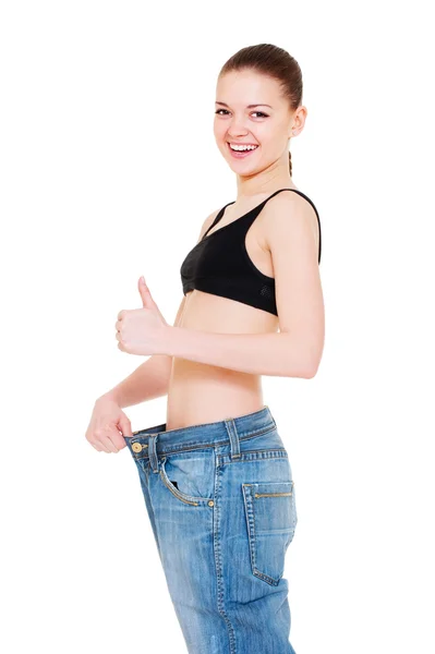 Kvinnan i stora jeans visar tummen upp — Stockfoto