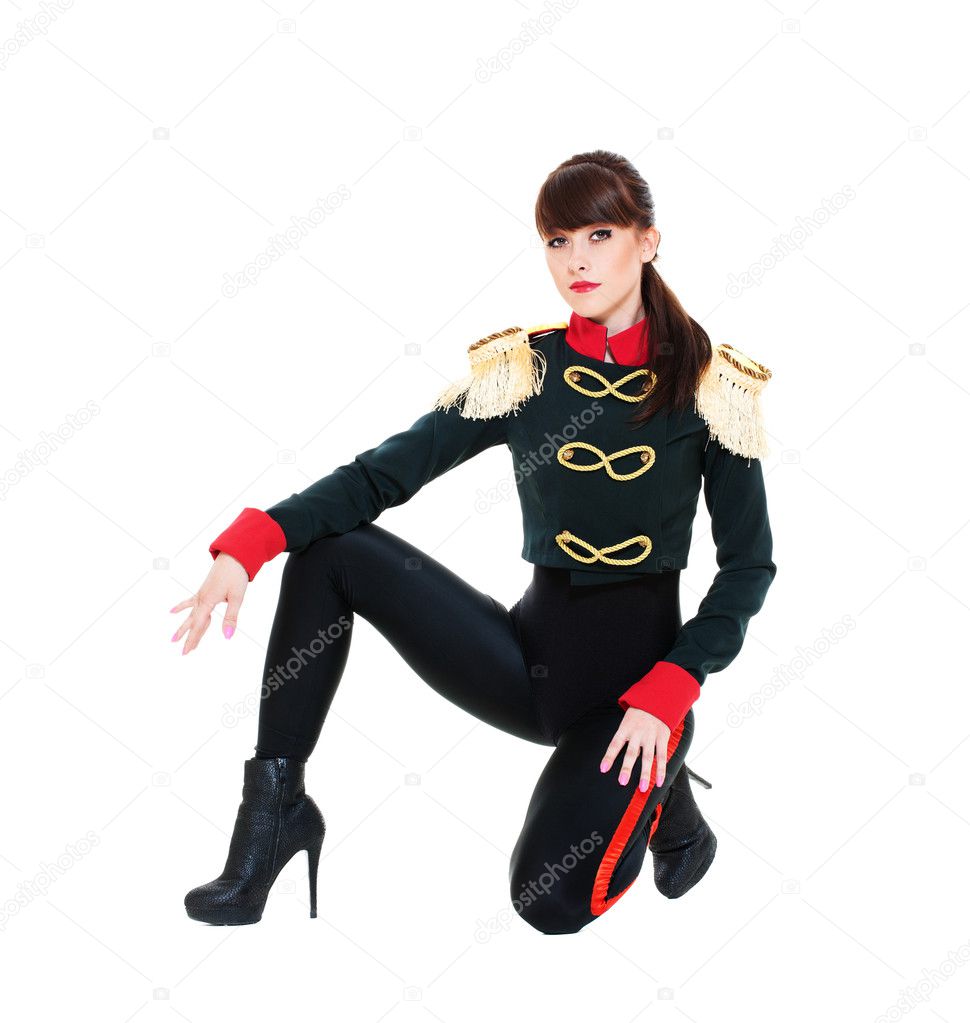 Alluring model in stage costume sitting