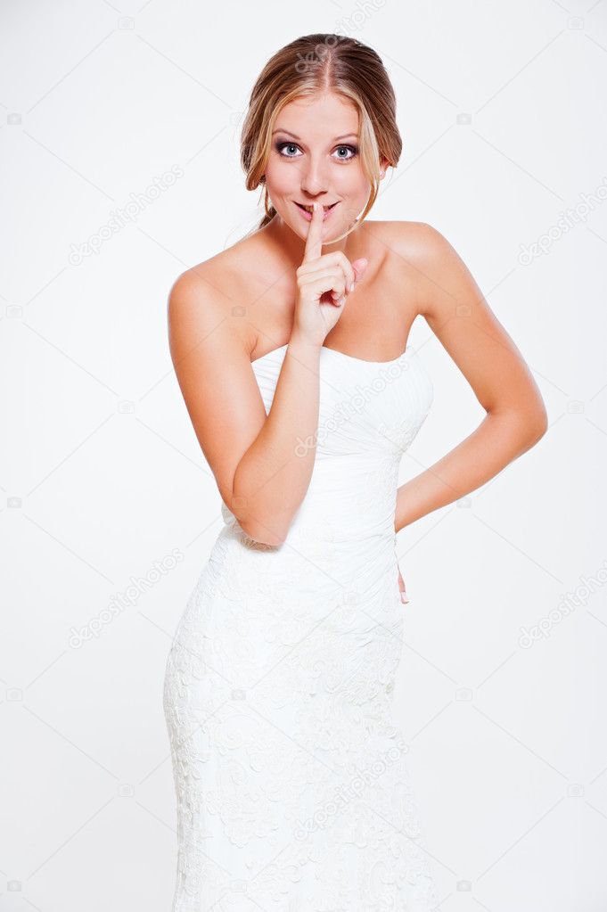 Happy bride making silence sign