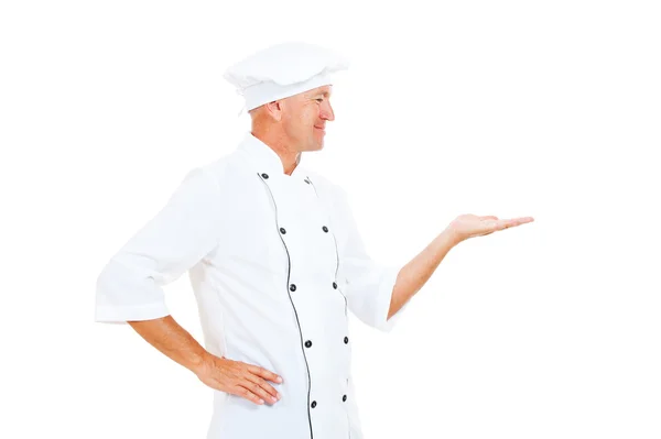 Vrolijke chef-kok houden iets op zijn palm — Stockfoto