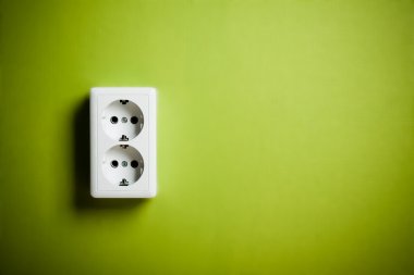 White electric socket on the wall. clipart