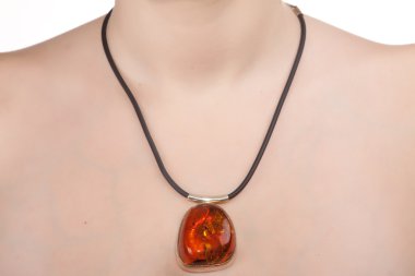 Amber jewelry on female neck. clipart