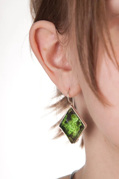 Κεχριμπάρι σκουλαρίκι στο αυτί θηλυκό. — Φωτογραφία Αρχείου