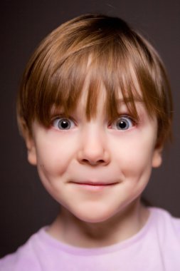 Portrait of a child on a black background. clipart