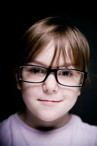 Portrait of a child on a black background. — Stock Photo, Image