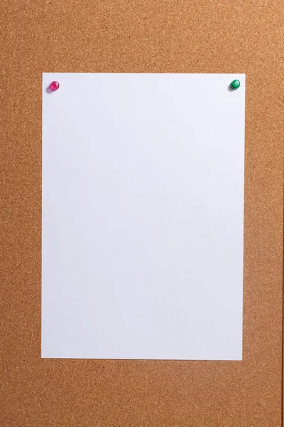 Paper with push pins on cork board. — Stock Photo, Image