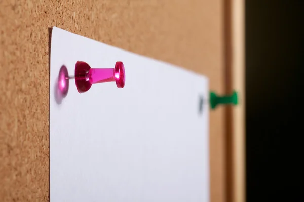 Paper with push pins on cork board. — Stock Photo, Image