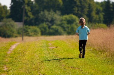 Child goes on a country road. clipart