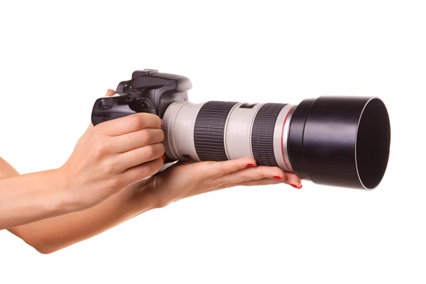 Women's hands holding the camera. Stock Picture