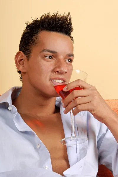 Smiling young man with cocktail — Stock Photo, Image