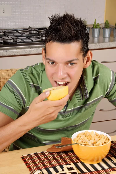 Young man having breakfast — Stock Photo, Image