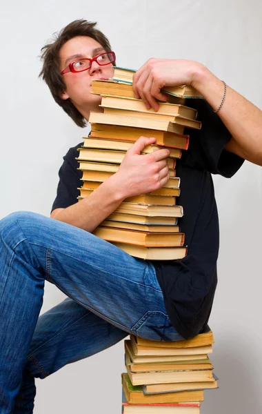 The student and his mountain textbooks — Stock Photo, Image