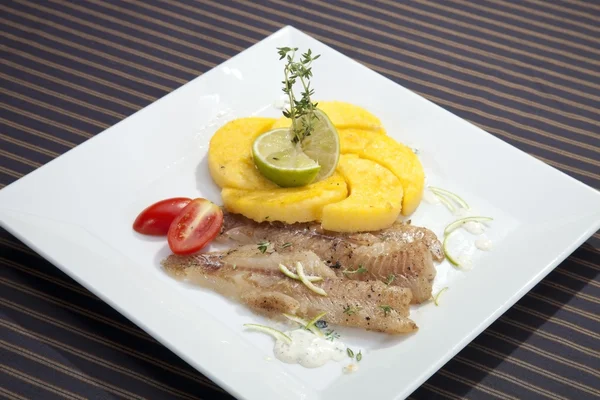 Grilled codfish with baked corn polenta — Stockfoto