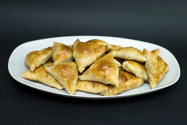 Asian pies with meat samsa, on the black background — Stock Photo, Image
