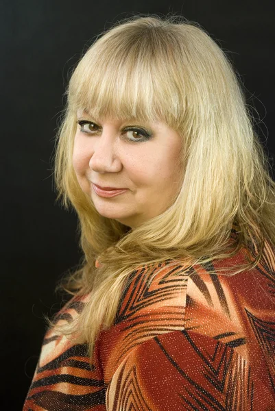 stock image Middle-aged woman posing on a black background