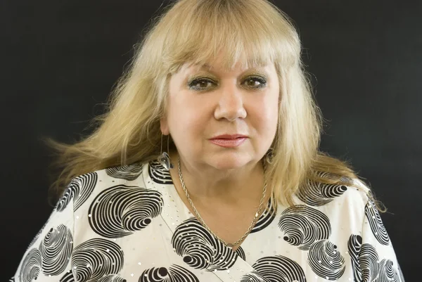 stock image Middle-aged woman posing on a black background