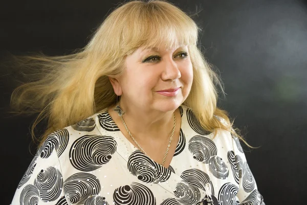 stock image Middle-aged woman posing on a black background