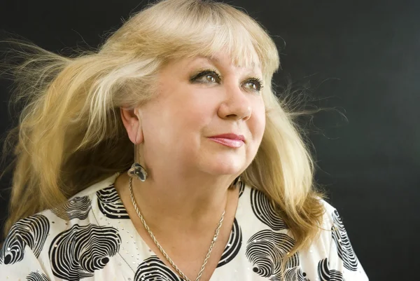 stock image Middle-aged woman posing on a black background